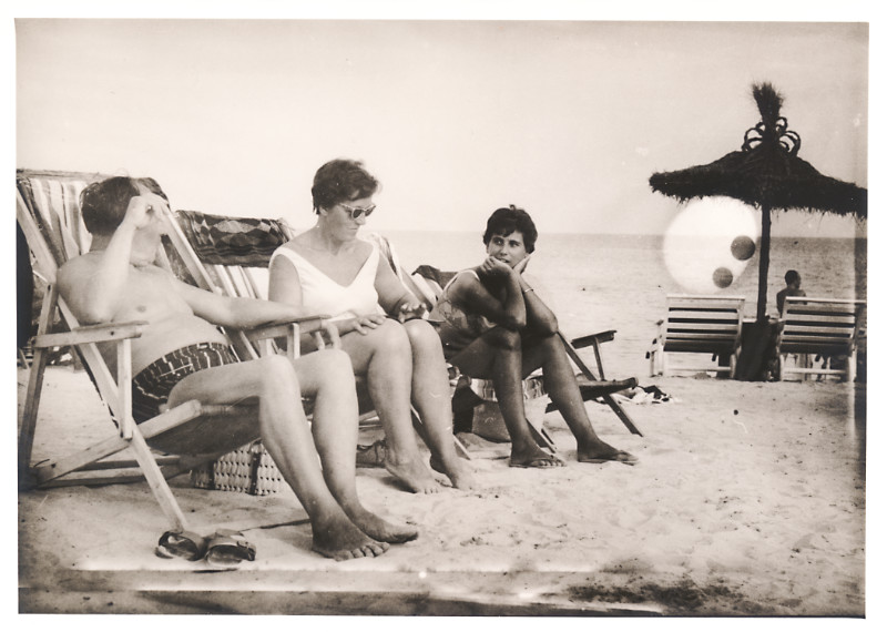Familie in Liegenstühle sitzend am Strand
